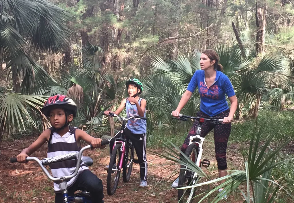 A family mountain biking through the woods