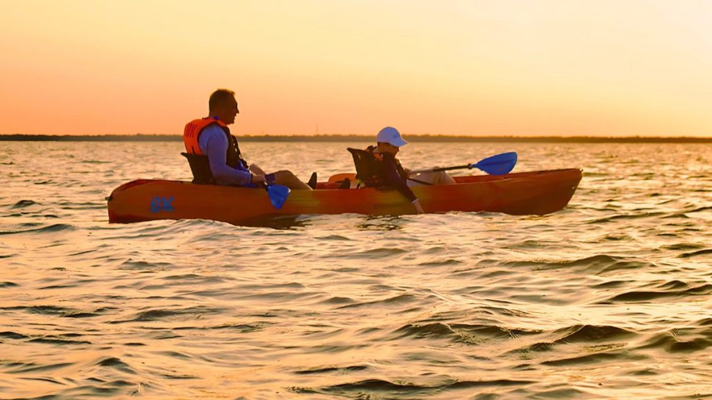 Father and child kayaking at sunset on Florida’s Space Coast with BK Adventure