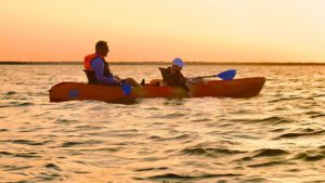 Father and child kayaking at sunset on Florida’s Space Coast with BK Adventure