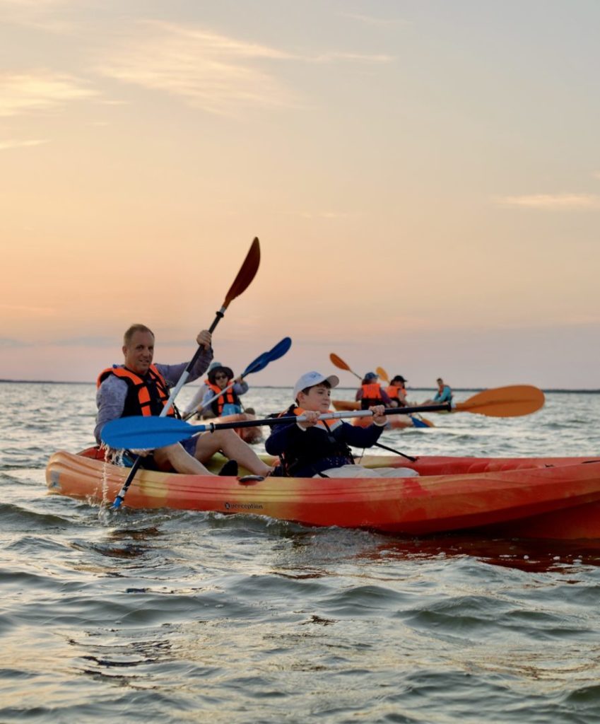 Father and child kayaking at sunset on Florida’s Space Coast with BK Adventure