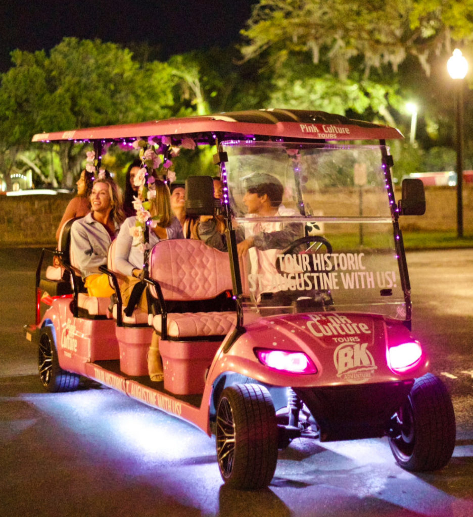 A group of guests on a St. Augustine Pink Culture Golf Cart Tour